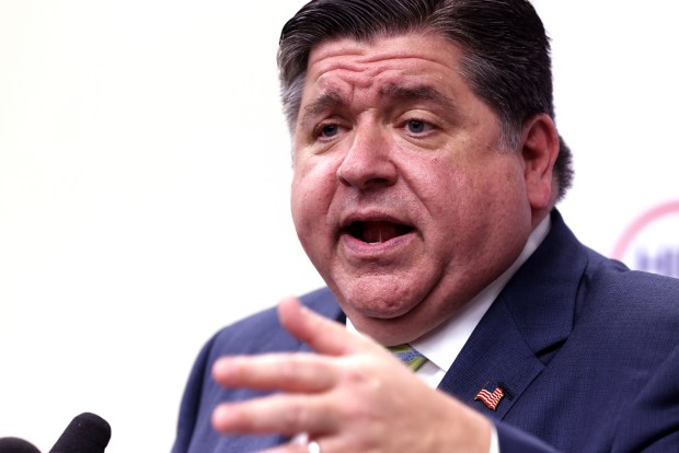 Gov. JB Pritzker speaks with reporters after the HIRE 360 Grand Opening to unveil the Training and Business Development Center on Sept. 26, 2024. At an unrelated event on Wednesday, Dec. 11, Pritzker gave assurances that Illinois would protect all immigrants with the exception of undocumented people convicted of violent crimes. Two days earlier, Tom Homan, President-elect Donald Trump's "border czar," said the threatened mass deportations of undocumented immigrants would begin in Chicago. (Antonio Perez/Chicago Tribune)