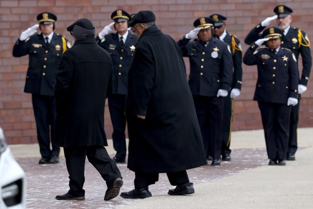 Members of the Oak Park Police salute as family arrives for Oak Park police Detective Allan Reddins, and his funeral services at Apostolic Church in Chicago on Dec. 12, 2024. (Antonio Perez/Chicago Tribune)