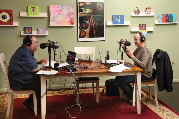 Hosts of Sound Opinions, a radio show on music, Jim DeRogatis, left, and Greg Kot record an episode at DeRogatis' home studio on Nov. 22, 2024. The show will air its 1,000th episode in January. (Antonio Perez/Chicago Tribune)