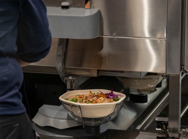 Salads come off the new Infinite Kitchen robotic system at Sweetgreen during a test run on Dec. 15, 2024, at Willis Tower. (Brian Cassella/Chicago Tribune)