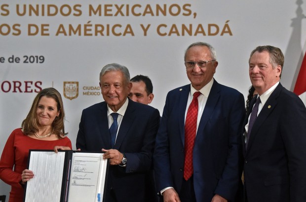 Mexican President Andres Manuel Lopez Obrador, second from left, and Canadian Vice-Prime Minister Chrystia Freeland, left, hold a document next to U.S. Trade Representative Robert Lighthizer, right, and Mexican negotiator Jesus Seade after signing an agreement in Mexico City on Dec. 10, 2019. Jamieson Greer has been tapped for Lighthizer's post during the second Trump administration, according to sources.(Rodrigo Arangua/ AFP/Getty Images/TNS)