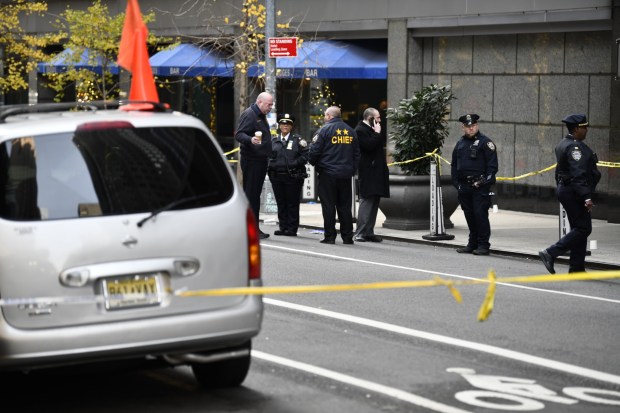 Investigators outside the New York Hilton Midtown, where Brian Thompson, the chief executive of UnitedHealthcare, was fatally shot in what police believe was a targeted attack on the morning of Dec. 4, 2024. Police officers were still searching for the gunman, who fled east on foot along Sixth Avenue. (Karsten Moran/The New York Times)