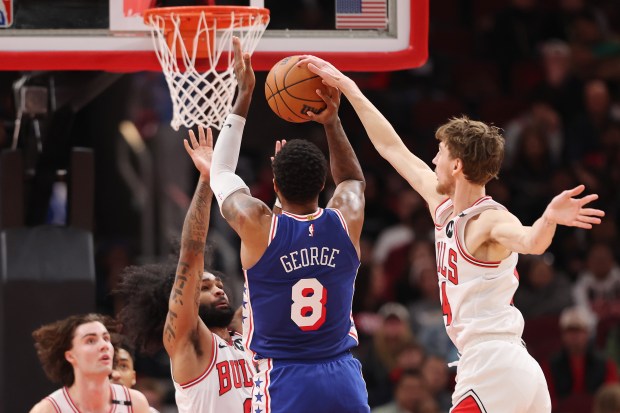 Matas Buzelis #14 of the Chicago Bulls blocks a shot by Paul George #8 of the Philadelphia 76ers during the second half at the United Center on Dec. 08, 2024 in Chicago, Illinois. NOTE TO USER: User expressly acknowledges and agrees that, by downloading and or using this photograph, User is consenting to the terms and conditions of the Getty Images License Agreement. (Photo by Michael Reaves/Getty Images)