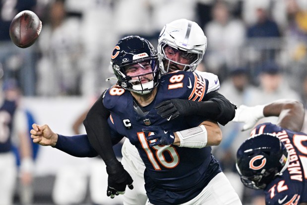 Jonathan Greenard of the Minnesota Vikings strips sacks Caleb Williams of the Chicago Bears with Kiran Amegadjie falling behind during the first quarter on Dec. 16, 2024, in Minneapolis. (Stephen Maturen/Getty Images)