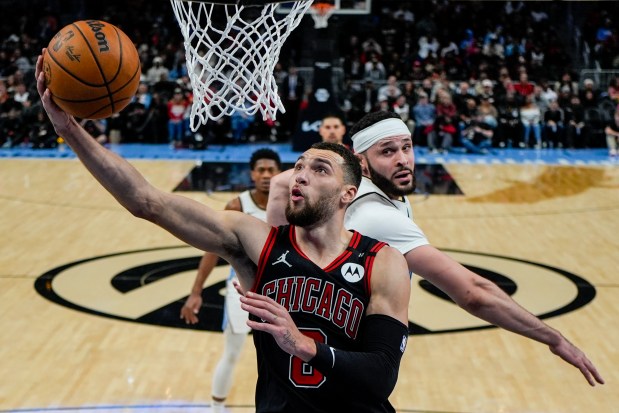 Bulls guard Zach LaVine shoots against Hawks forward Larry Nance Jr. during the first half on Dec. 26, 2024, in Atlanta. (Mike Stewart/AP)