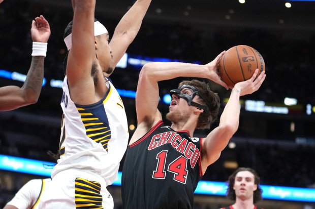 The Bulls' Matas Buzelis (14) drives to the basket against the Pacers' Andrew Nembhard during the first half on Dec. 6, 2024, at the United Center. (Charles Rex Arbogast/AP)