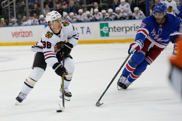 New York Rangers' K'Andre Miller (79) defends Chicago Blackhawks' Connor Bedard (98) during the third period of an NHL hockey game Monday, Dec. 9, 2024, in New York. (AP Photo/Frank Franklin II)