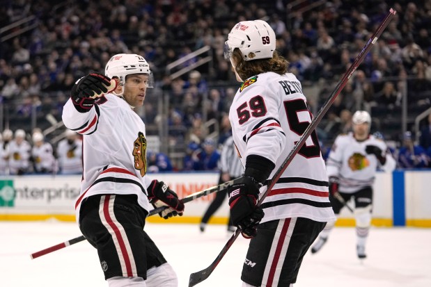 Chicago Blackhawks' Taylor Hall, left, celebrates with Tyler Bertuzzi (59) Bertuzzi scored a goal during the first period of an NHL hockey game against the New York Rangers Monday, Dec. 9, 2024, in New York. (AP Photo/Frank Franklin II)