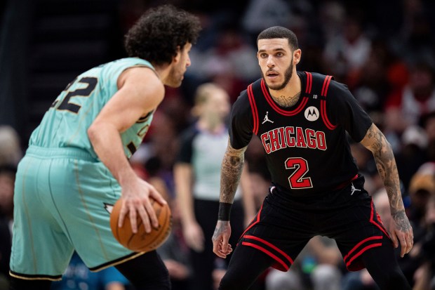 Chicago Bulls guard Lonzo Ball (2) defends against Charlotte Hornets guard Vasilije Micic during the first half of an NBA basketball game in Charlotte, N.C., Monday, Dec. 30, 2024. (AP Photo/Jacob Kupferman)