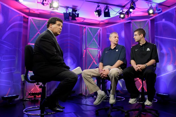 Greg Gumbel, left, watches as Connecticut coach Jim Calhoun, center, talks with Butler coach Brad Stevens before taping a television interview for the Final Four on April 3, 2011, in Houston. (Eric Gay/AP)