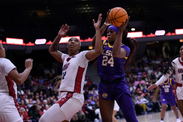 LSU's Aneesah Morrow (24), battles UIC's Keimari Rimmer for a rebound during the first half of an NCAA college basketball game, Thursday, Dec. 19, 2024, in Chicago. (AP Photo/Paul Beaty)