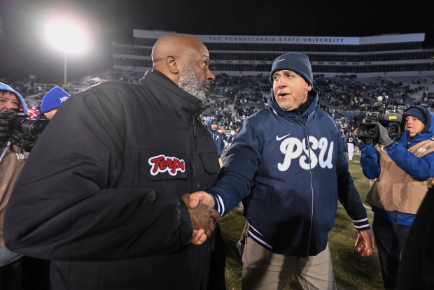 Penn State head coach James Franklin, front right, talks with Maryland head coach Mike Locksley, left, following an NCAA college football game, Saturday, Nov. 30, 2024, in State College, Pa. (AP Photo/Barry Reeger)