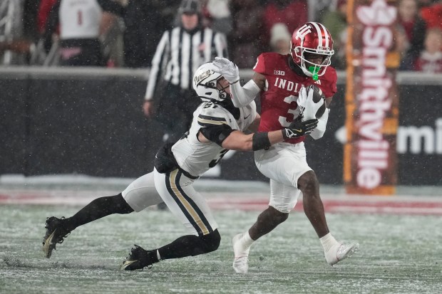 Indiana wide receiver Omar Cooper Jr. (3) is tackled by Purdue defensive back Dillon Thieneman (31) during the first half of an NCAA college football game, Saturday, Nov. 30, 2024, in Bloomington, Ind. (AP Photo/Darron Cummings)