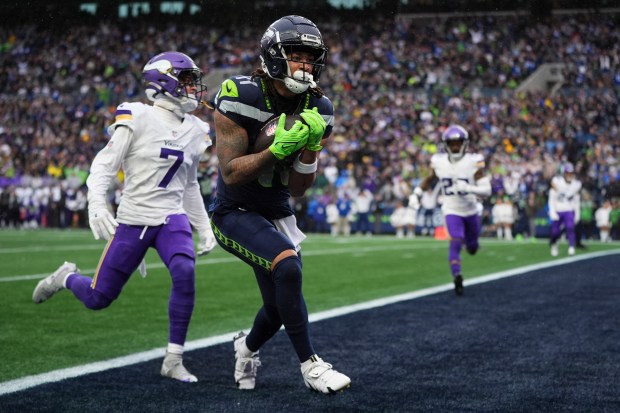 Seattle Seahawks wide receiver Jaxon Smith-Njigba brings in a touchdown against Minnesota Vikings cornerback Byron Murphy Jr. (7) during an NFL football game Sunday, Dec. 22, 2024, in Seattle. (AP Photo/Lindsey Wasson)