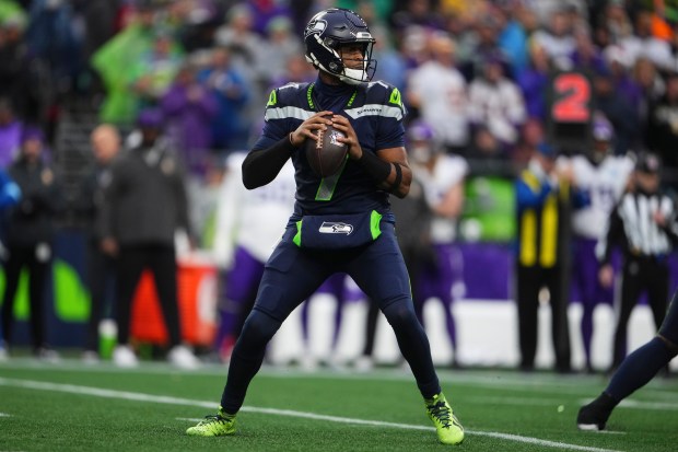 Seattle Seahawks quarterback Geno Smith looks to throw the ball against the Minnesota Vikings during an NFL football game Sunday, Dec. 22, 2024, in Seattle. (AP Photo/Lindsey Wasson)