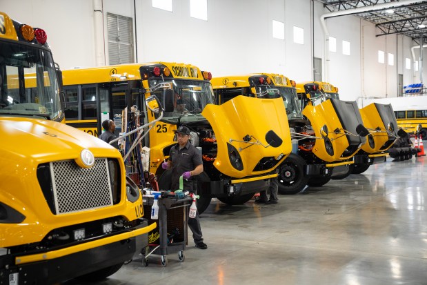 Electric school buses receive finishing touches before being delivered to customers at the Lion Electric plant in Joliet on July 23, 2024. Quebec-based announced that it is suspending operations at its Illinois plant and temporarily laying off approximately 400 workers, in both Canada and the U.S. (E. Jason Wambsgans/Chicago Tribune)