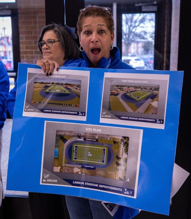 A poster on display at an announcement event at Larkin High School shows an image for a new sports stadium that's to be build at the Elgin school. (School District U-46)