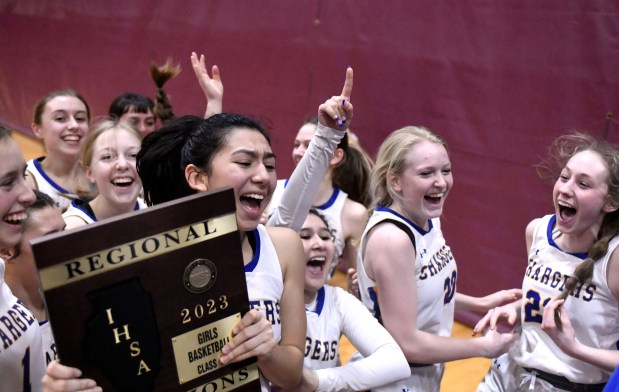 Sofia Corral holds the plaque after Aurora Central Catholic defeated the host Indians in the Class 2A Marengo Regional championship game on Friday, Feb. 17, 2023.