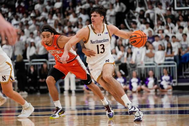 Illinois guard Dra Gibbs-Lawhorn defends Northwestern guard Brooks Barnhizer during the second half of the Wildcats' 70-66 overtime win Dec. 6, 2024, in Evanston. (AP Photo/Erin Hooley)