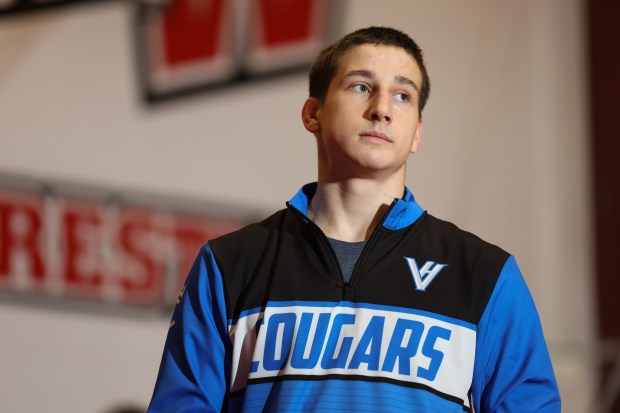 Vernon Hill's Ilia Dvoriannikov talks with the Niles West captains at the start of a dual meet at Niles West High School in Niles on Friday, Dec. 13, 2024. (Talia Sprague / News-Sun)