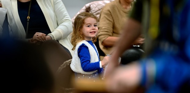 Center, watching audience participants and The Spoon Man variety entertainer Jim Cruise of Jenison, Michigan is Elizabeth "Lizzie" Goldshtein of Sunnyvale, California. Lizzie's grandparents reside in Vernon Hills. Taken at the Chabad Jewish Center of Vernon Hills Community Chanukah Celebration on Sunday, Dec. 29, 2024 in Vernon Hills. (Karie Angell Luc/Lake County News-Sun)