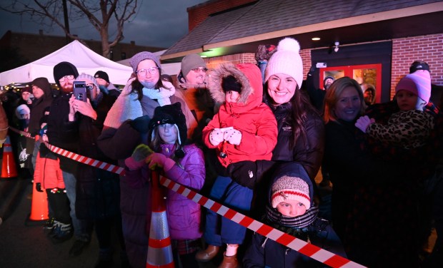 Families on the Center Street parade route wait for a glimpse of Santa Claus at the Festival of Lights and Holiday Market on Nov. 29, 2024 in downtown Grayslake. (Karie Angell Luc/Lake County News-Sun)