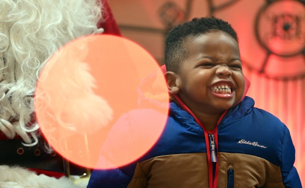 Keon Selner, 3, of Grayslake shows delight being with Santa Claus at the Festival of Lights and Holiday Market on Nov. 29, 2024 in downtown Grayslake. (Karie Angell Luc/Lake County News-Sun)