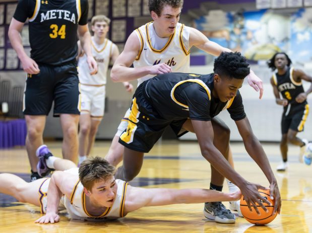 Metea Valley's Tre Watkins (3) fights for a loose ball with Downers Grove North's Bobby Grant (10) during a game in the in the Downers Grove North Thanksgiving Invitational on Saturday, Nov. 30, 2024. (Troy Stolt / for the Daily Southtown)