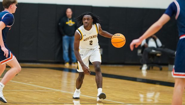 Metea Valley's Khalil Jones (2) brings the ball up the court against Naperville North's Jack Zitko (12) during a basketball game at Metea Valley High School in Aurora on Friday, Dec. 20, 2024. (Sean King / for The Naperville-Sun)