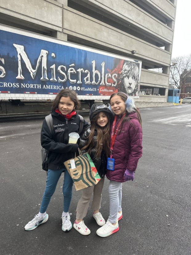 Emerson Mae Chan, 9, of Naperville pictured (right) outside of a "Les Misérables" marquee. Emmy Chan is performing as little Cosette and young Eponine in the national Broadway tour of "Les Misérables." The tour will be stopping in Chicago for a three-week stint at the Cadillac Palace Theatre at 151 . Randolph St. from Dec. 17 to Jan. 5. (Lindsay Chan)