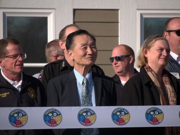 Dr. Jai J. Nho, center, attends the ribbon cutting for the Frontline Care Center Dec. 9. Nho had donated his Round Lake office building after retiring, kickstarting the creation of the mental health facility. (Joe States/Lake County News-Sun)