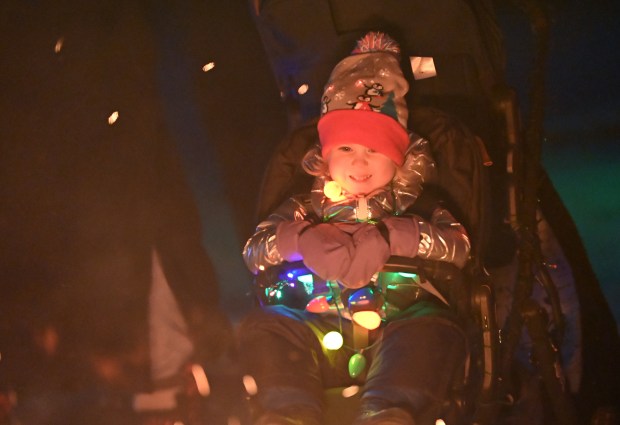 Ava Scovil, 2, of Winnetka looks at the fire at the ninth annual Winter Solstice Trail of Lights event and parade on Dec. 20, 2024 in Glencoe at Shelton Park. (Karie Angell Luc/Pioneer Press)