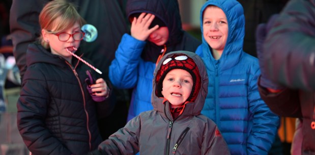 In Spider-Man hat, and seeing Santa Claus arrive in the decorated Glenview fire engine is Alex Kruzel, 4, of Glenview during the Nov. 30, 2024 Holiday in the Park and Parade in downtown Glenview. (Karie Angell Luc/Pioneer Press)