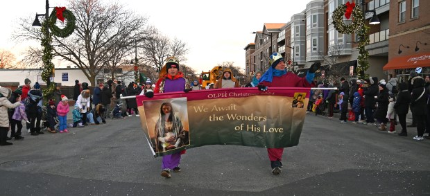 Members of the Our Lady of Perpetual Church of Glenview living nativity walk on Glenview Road including the Tirpak family of Glenview on Nov. 30, 2024 during the Holiday in the Park and Parade in downtown Glenview. (Karie Angell Luc/Pioneer Press)