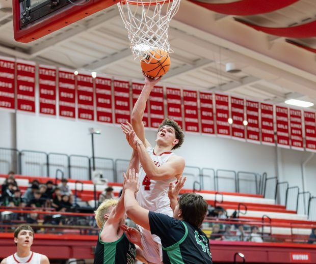 Hinsdale Central's Vincas Buzelis (4) goes up for a layup against York during a West Suburban Conference game in Hinsdale on Saturday, Dec. 14, 2024. (Troy Stolt / for the Pioneer Press)