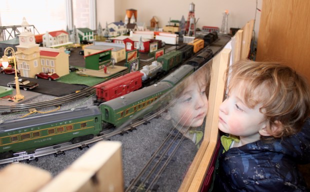 Shane Wasserman, 3, of Deerfield enjoys the journey of the model train during Deerfield's Winter Holiday Market Saturday at the Patty Turner Center, a train display created by Deerfield resident, Richard Southon. (Gina Grillo/ For the Pioneer Press)