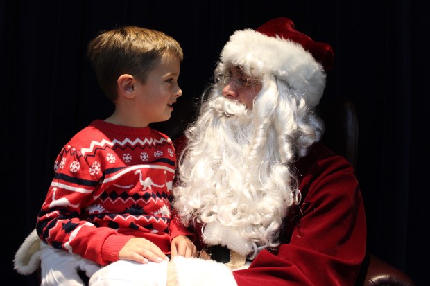 Braden Senko, 6, connects with Santa Claus during the Kiwanis Pancake Breakfast with Santa held from 7 a.m. to noon Saturday, Dec 7, at Grace United Methodist Church in Lake Bluff. (Gina Grillo/ For the Pioneer Press)