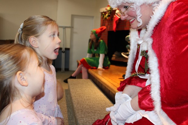 Addie Clemens, 5, and Cassidy Clemens, 3, join Mrs. Claus during the annual Kiwanis Pancake Breakfast with Santa held on Saturday, Dec 7 at Grace United Methodist Church in Lake Bluff. (Gina Grillo/ For the Pioneer Press)