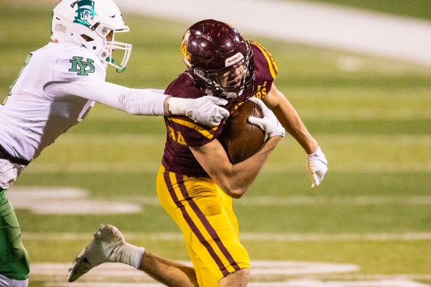 Loyola's Drew MacPherson (34) slips past a York's Aidan Link (3) on his way to a first down in the Class 8A state championship game at Hancock Stadium in Normal on Saturday, Nov. 30, 2024. (Vincent D. Johnson / for the Pioneer Press)