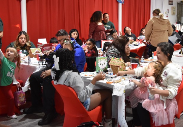 Families from the Franklin Park area gathered at Angel's Closet recently for a party store owner Angelita Bracero planned as a way to say thank you to the community. (Jesse Wright/Pioneer Press)