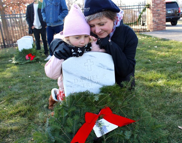 Daughter, Cindy Trew, with great-granddaughter, Raelen Betcher 6-years-old, honor Vietnam Veteran and U.S. Army Major, Daniel Robert Trew, buried at Fort Sheridan National Cemetery during the Fallen Hero Wreath Ceremony Saturday, Dec. 14. (Gina Grillo/ For the Pioneer Press)