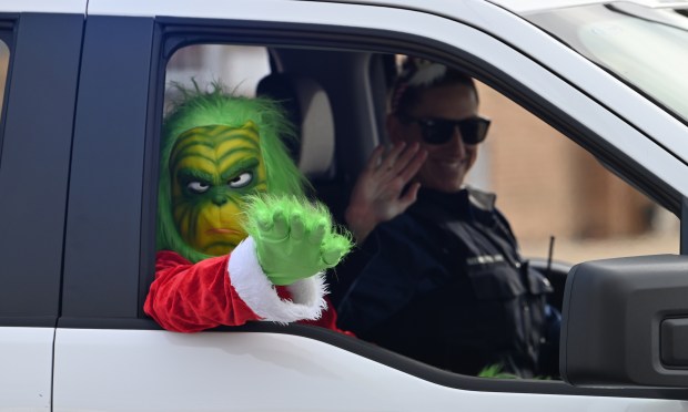 The Grinch makes his way down Lawrence Avenue at the Santa Send Off on Dec. 21, 2024 in Norridge. (Karie Angell Luc/Pioneer Press)