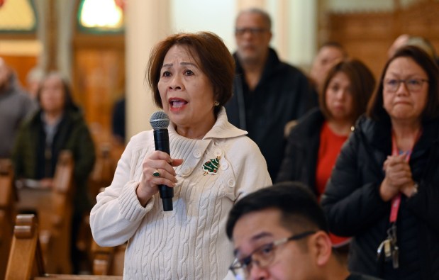 Left, reading from the screen along the altar is Nora Turcuato of Skokie for Simbang Gabi 2024 on Dec. 16, 2024 at Saints Peter and Lambert Parish (St. Peter Chapel) in Skokie. (Karie Angell Luc/Pioneer Press)