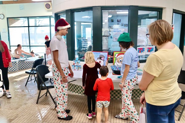  In addition to splashing around in the pool, games provided on the deck during the "Swim with Santa" event Dec. 21, 2024 at Centennial Fitness Center in Park Ridge. (Kaitlin Mikrut/for Pioneer Press).