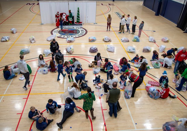 Children open presents and meet with Santa Claus during the Boys & Girls Clubs of NWI's "A Christmas to Remember" on Thursday, Dec. 6, 2024 at the Dean and Barbara White Community Center in Merrillville. (Michael Gard/for the Post-Tribune)