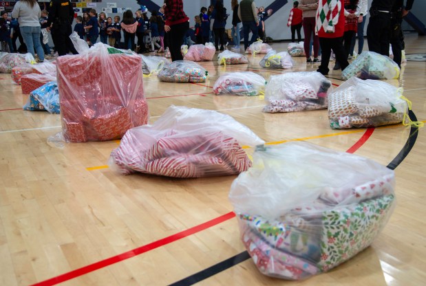 Bags of holiday gifts wait to be unwrapped during the Boys & Girls Clubs of NWI's "A Christmas to Remember" on Thursday, Dec. 6, 2024 at the Dean and Barbara White Community Center in Merrillville. (Michael Gard/for the Post-Tribune)