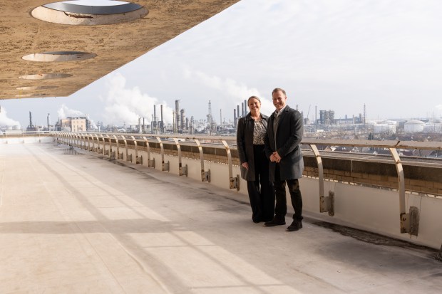 Calumet College President Amy McCormack and Chris DellaFranco, vice president of refining at BP's Whiting Refinery, stand on the terrace outside the seventh-floor Heritage Room at the campus administration building. (Photo courtesy of Calumet College)