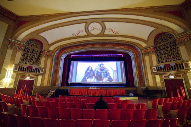 Chris Jamerson, writer and director of "The Exiles," watches his movie on-screen for the first time ahead of the film's Sunday premiere at the Hoosier Theatre in Whiting on Friday, Dec. 6, 2024. (Kyle Telechan/for the Post-Tribune)