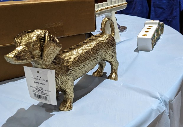 A gold metallic dachshund menorah is one of the gift items at Temple Israel's pop-up Hanukkah shop at the Gary synagogue. (Carole Carlson/Post-Tribune)