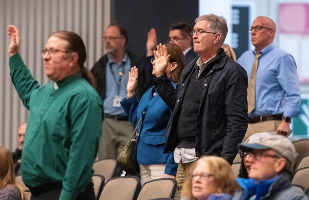 Members of the public are sworn in prior to giving testimony during a public hearing about proposed electric rate hikes for NIPSCO customers on Tuesday, Nov. 26, 2024 at Ivy Tech Community College in Valparaiso. (Michael Gard/for the Post-Tribune)